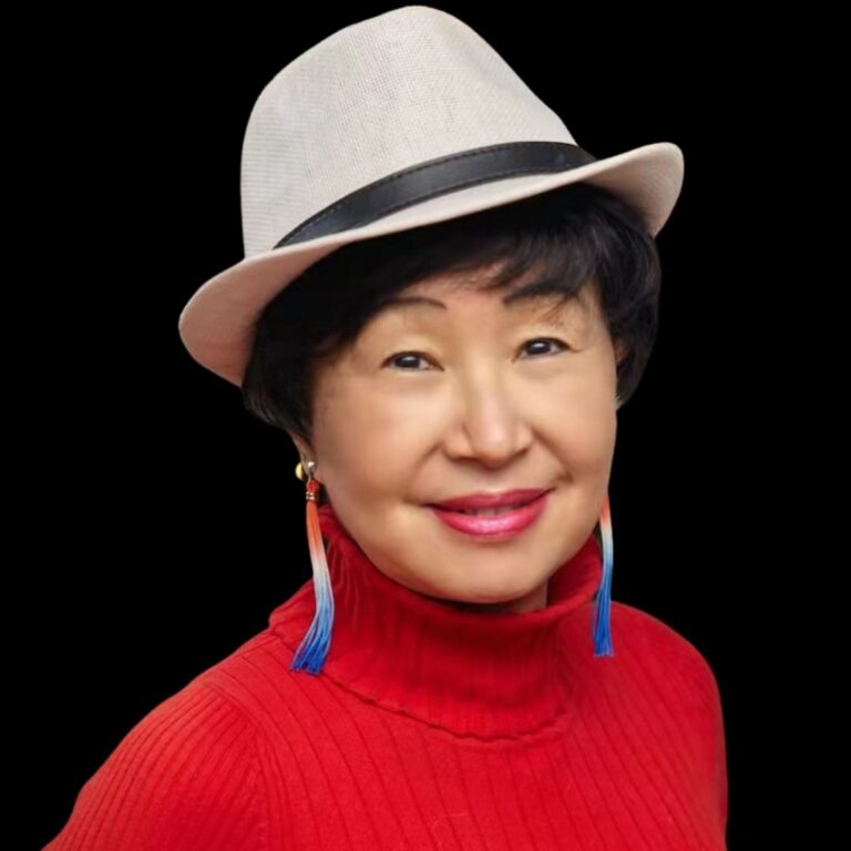 female with earings and dark hair and white hat in red top
